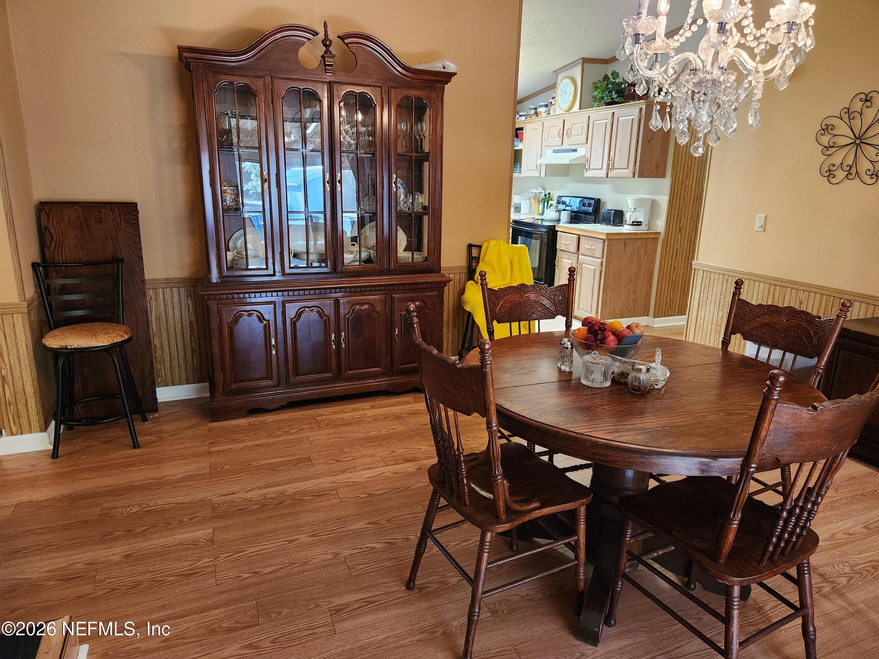 6863 Deer Springs Road Keystone Heights, FL 32656 - Photo 12 of 20 a view of a dining room with furniture and chandelier