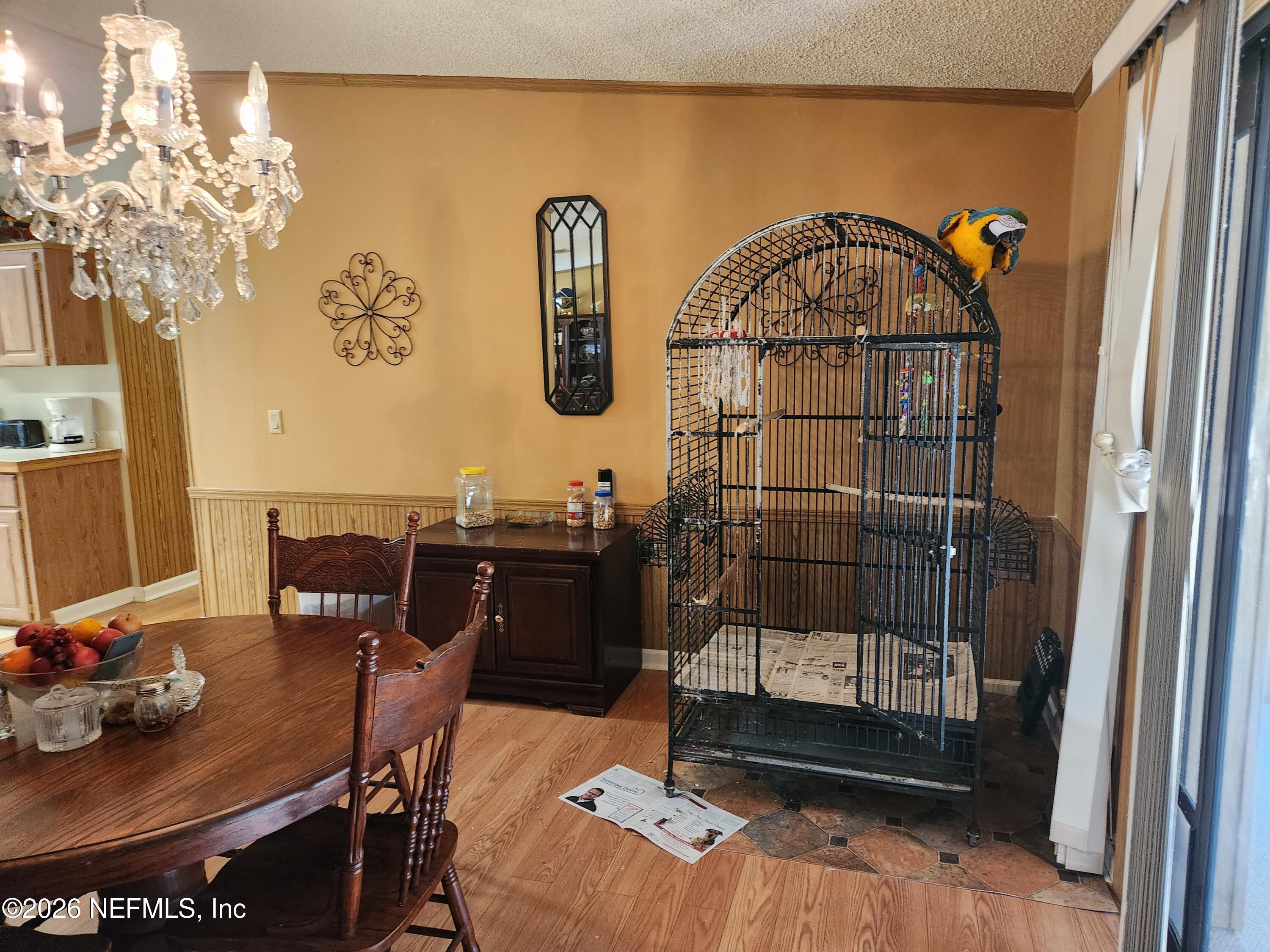 6863 Deer Springs Road Keystone Heights, FL 32656 - Photo 13 of 20 a view of a dining room with furniture and chandelier