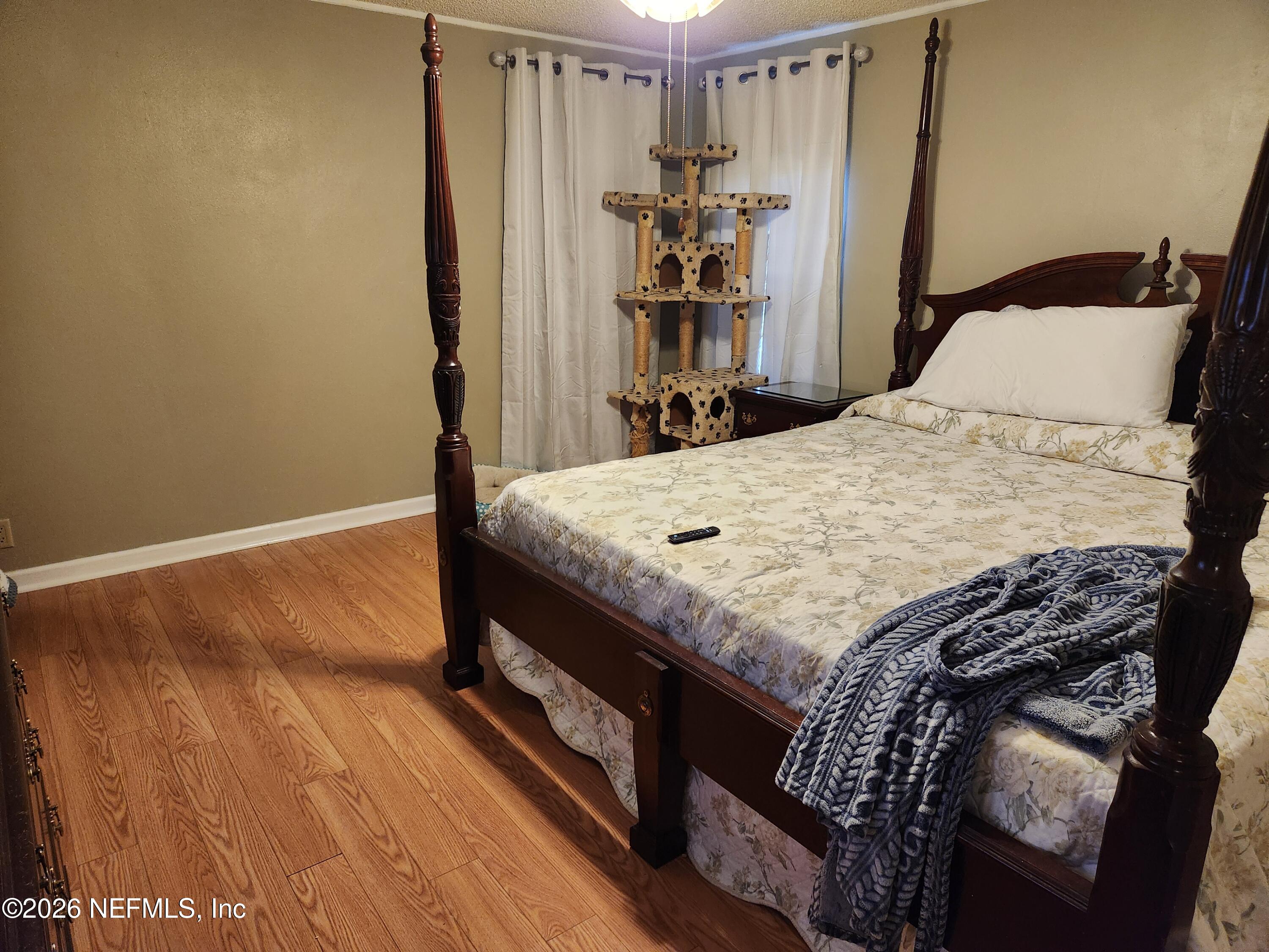 6863 Deer Springs Road Keystone Heights, FL 32656 - Photo 14 of 20 a bed sitting in a bedroom next to a window