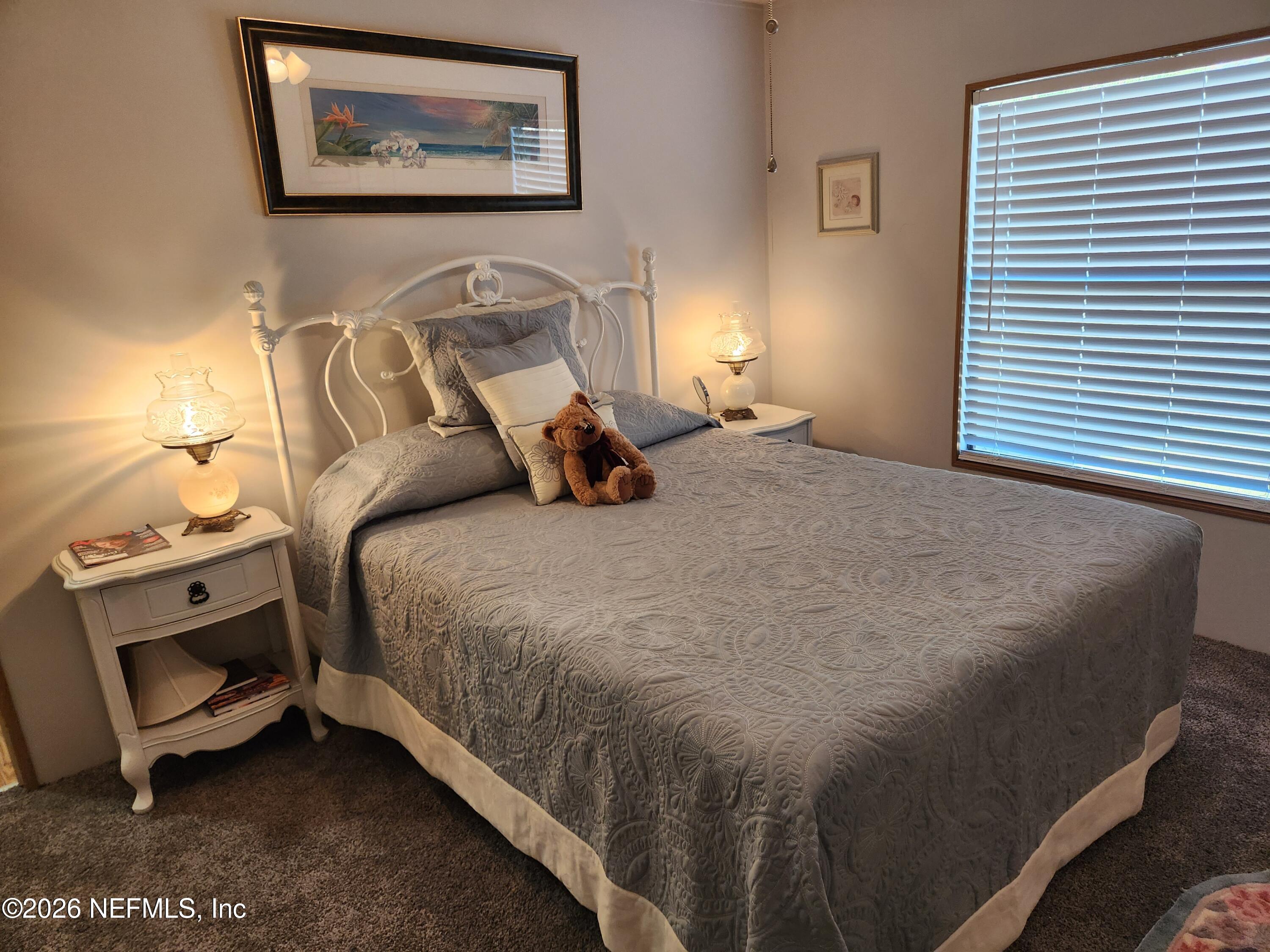 6863 Deer Springs Road Keystone Heights, FL 32656 - Photo 18 of 20 a bed sitting in a bedroom next to a window
