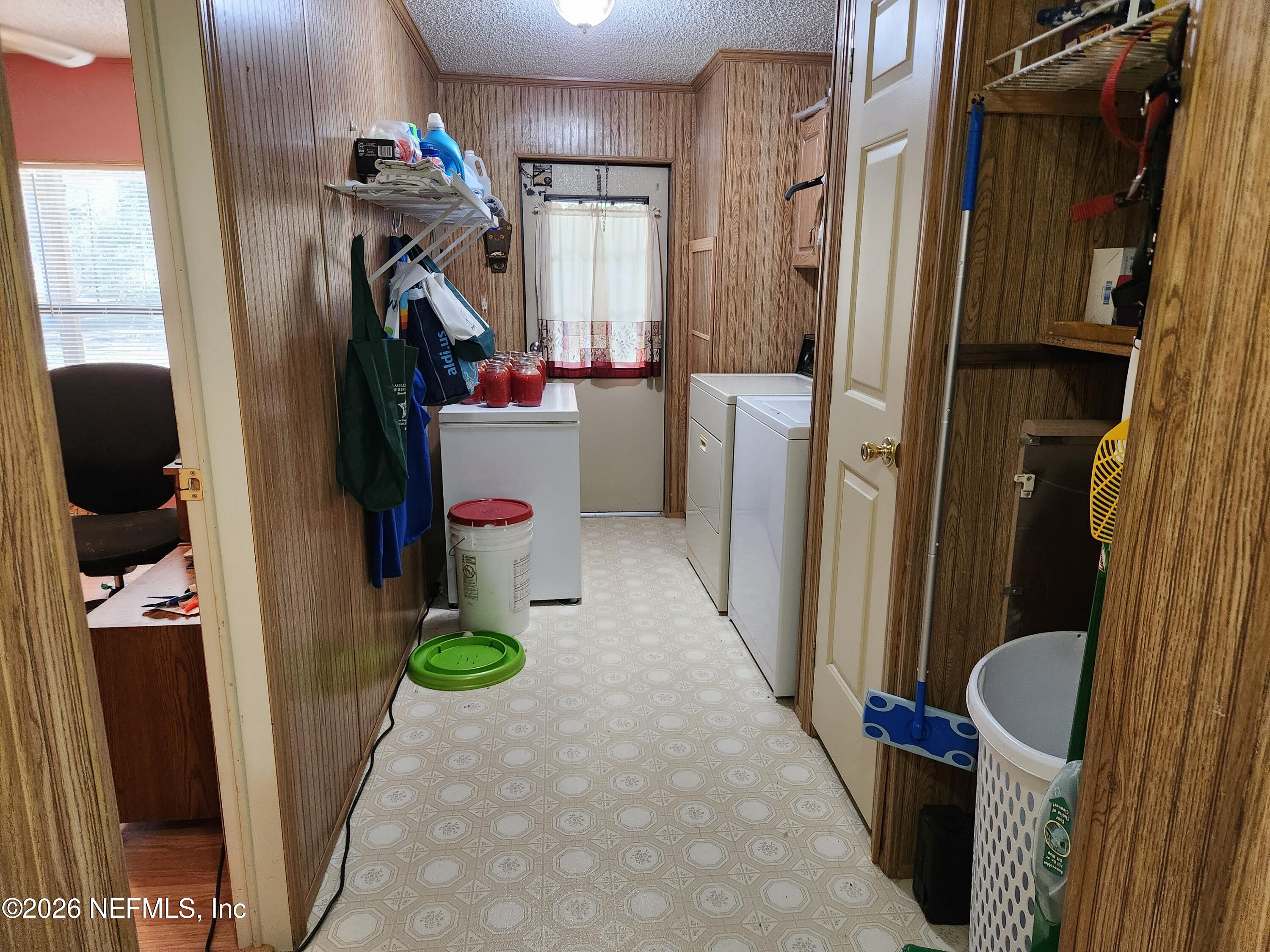 6863 Deer Springs Road Keystone Heights, FL 32656 - Photo 20 of 20 a view of walk in closet with clothes and shoes