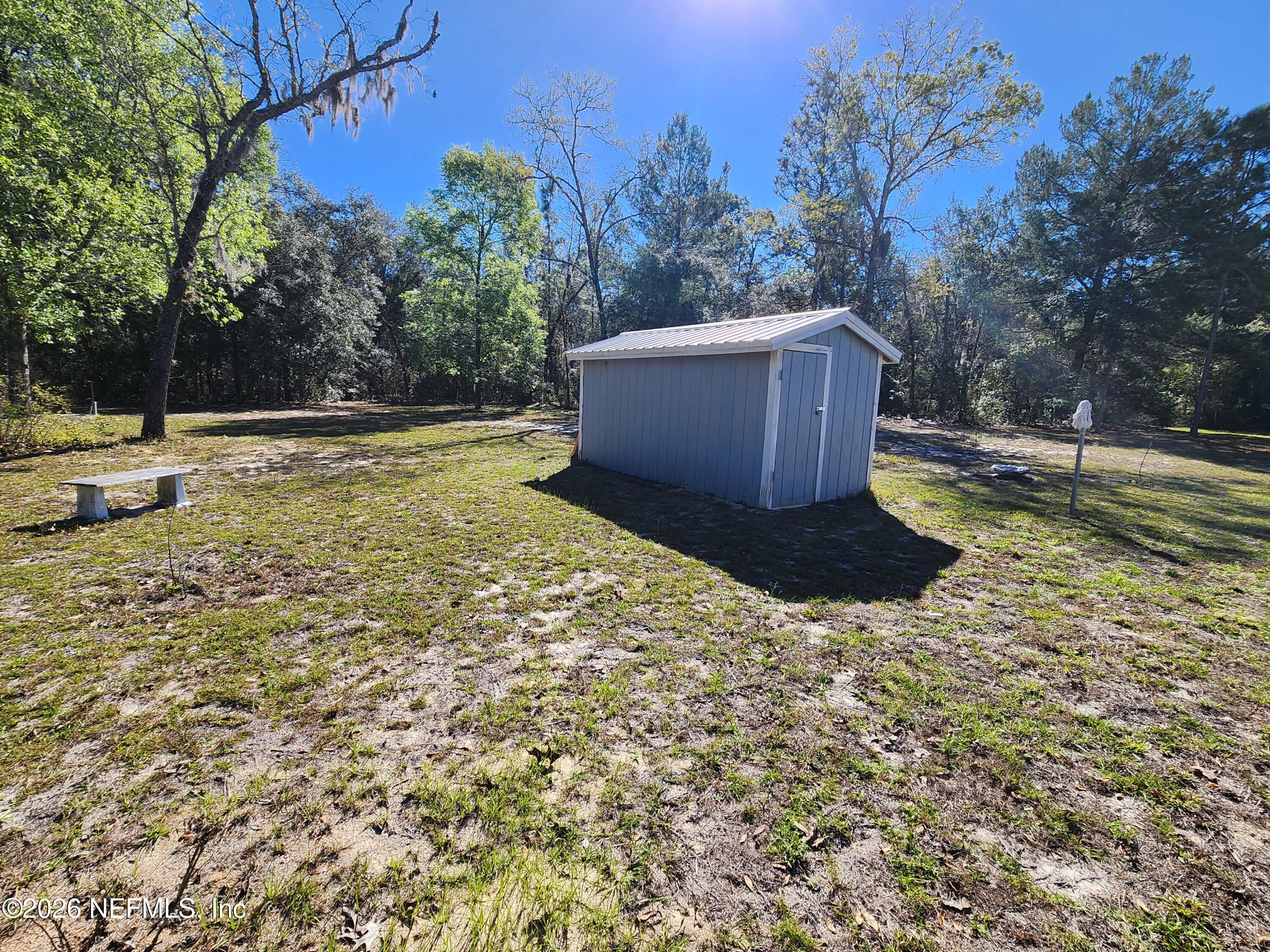 6863 Deer Springs Road Keystone Heights, FL 32656 - Photo 6 of 20 a view of a backyard with trees