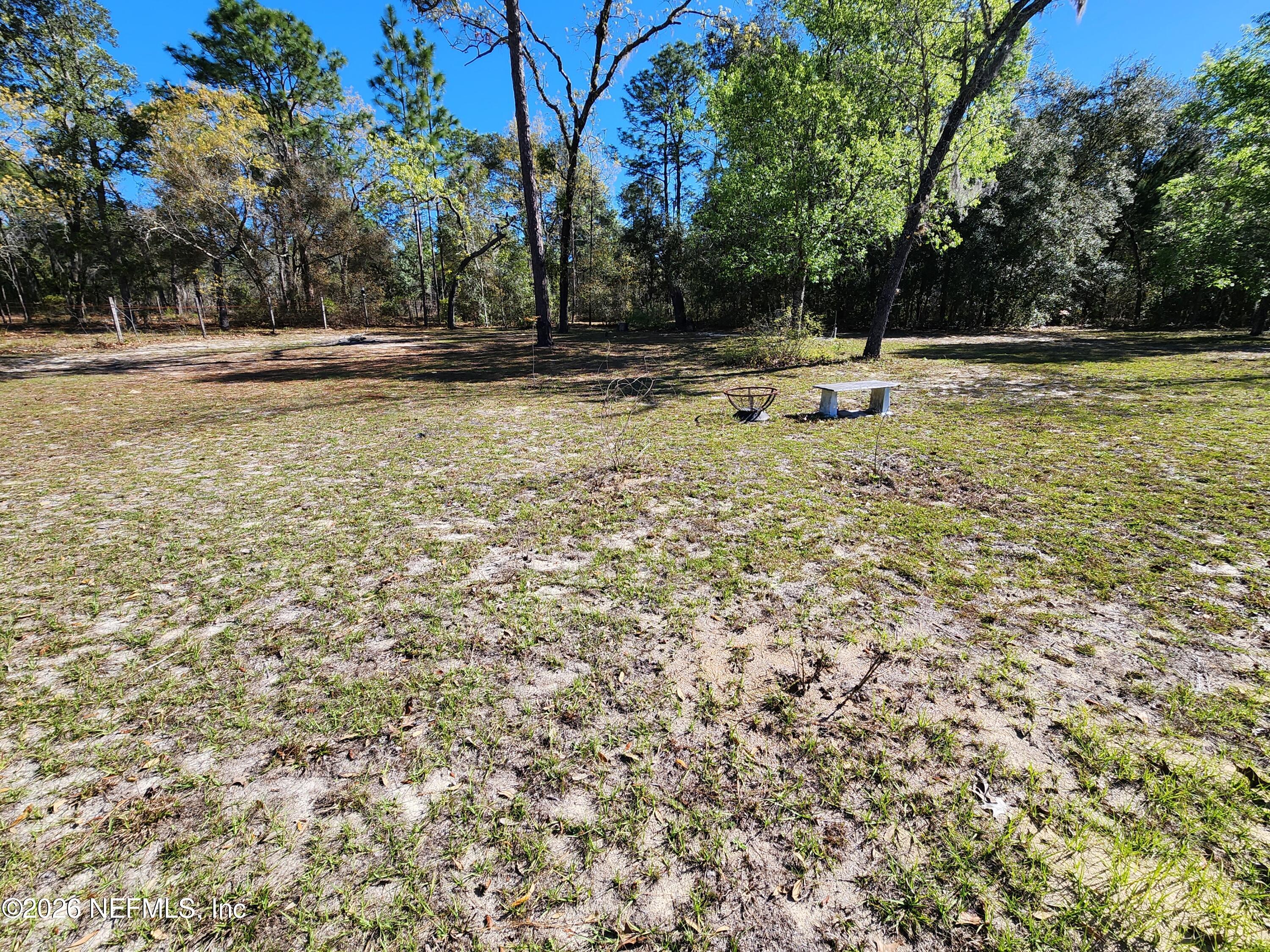 6863 Deer Springs Road Keystone Heights, FL 32656 - Photo 8 of 20 a view of a swimming pool with a yard