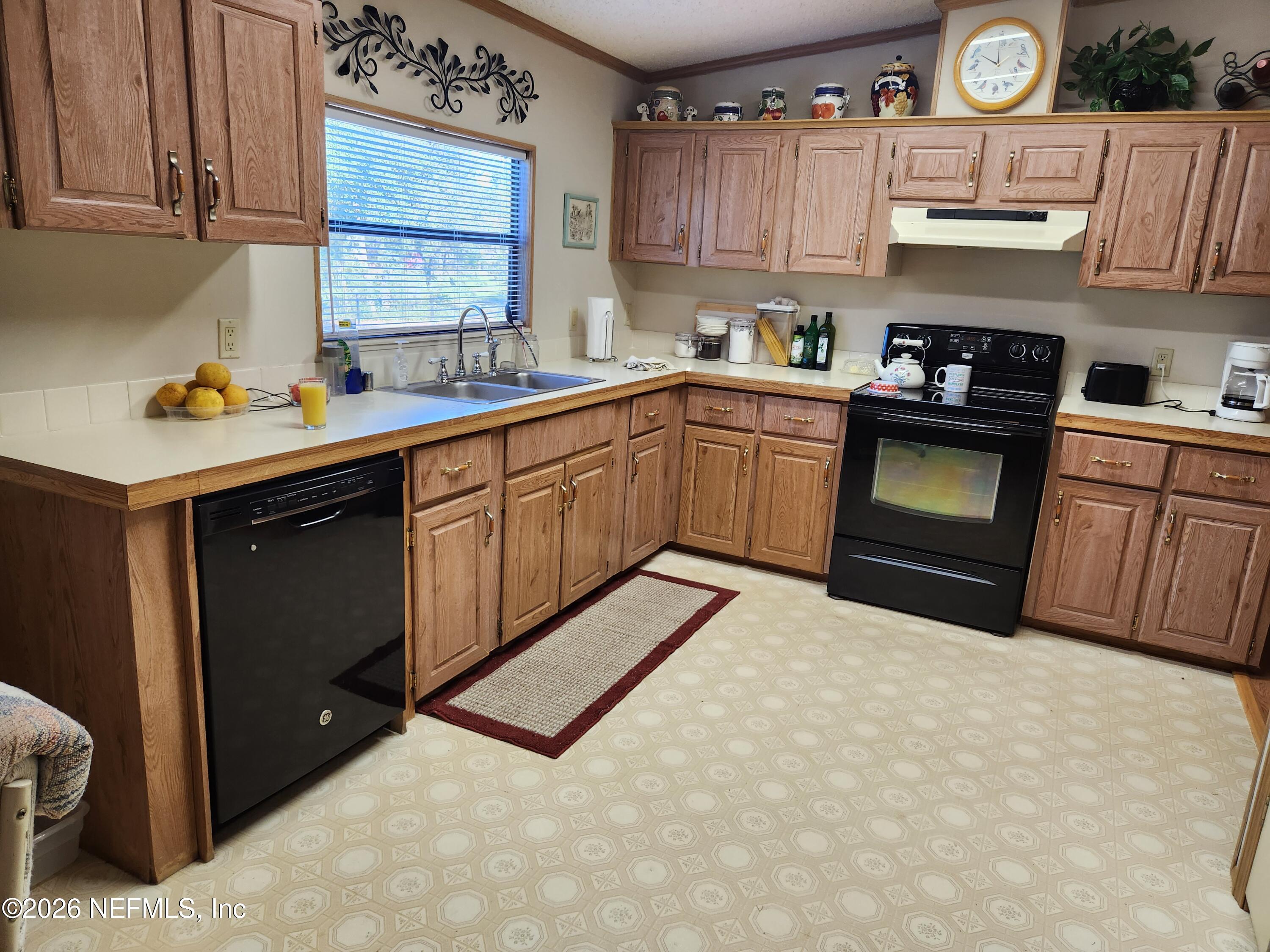 6863 Deer Springs Road Keystone Heights, FL 32656 - Photo 10 of 20 a kitchen with stainless steel appliances granite countertop a sink stove and refrigerator