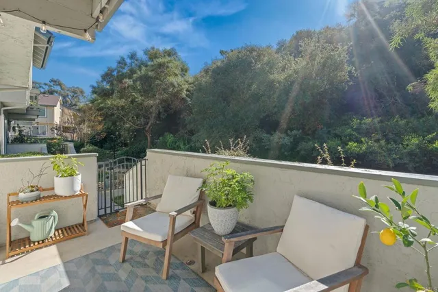 a view of a chairs and table in the balcony
