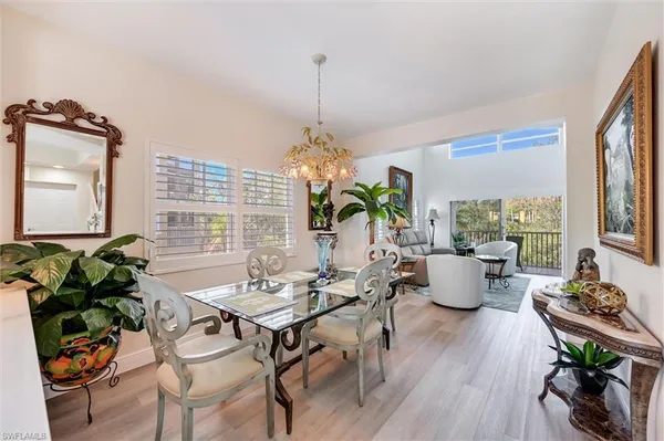 a living room with dining room and wooden floor