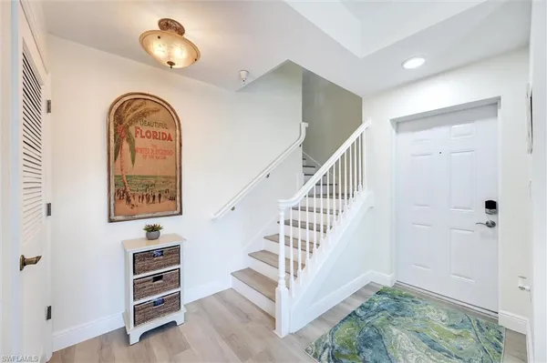 a bedroom with a large bed and a flat tv screen on dresser