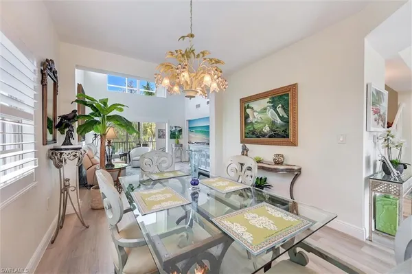 a dining room with furniture a rug and a chandelier