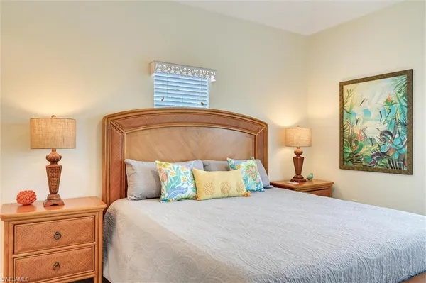 a bedroom with a bed and a lamp