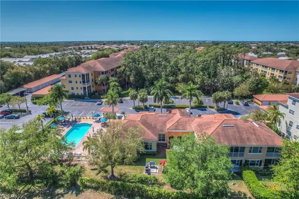 an aerial view of residential houses with outdoor space and street view