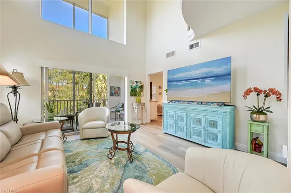 a living room with furniture fireplace and flat screen tv