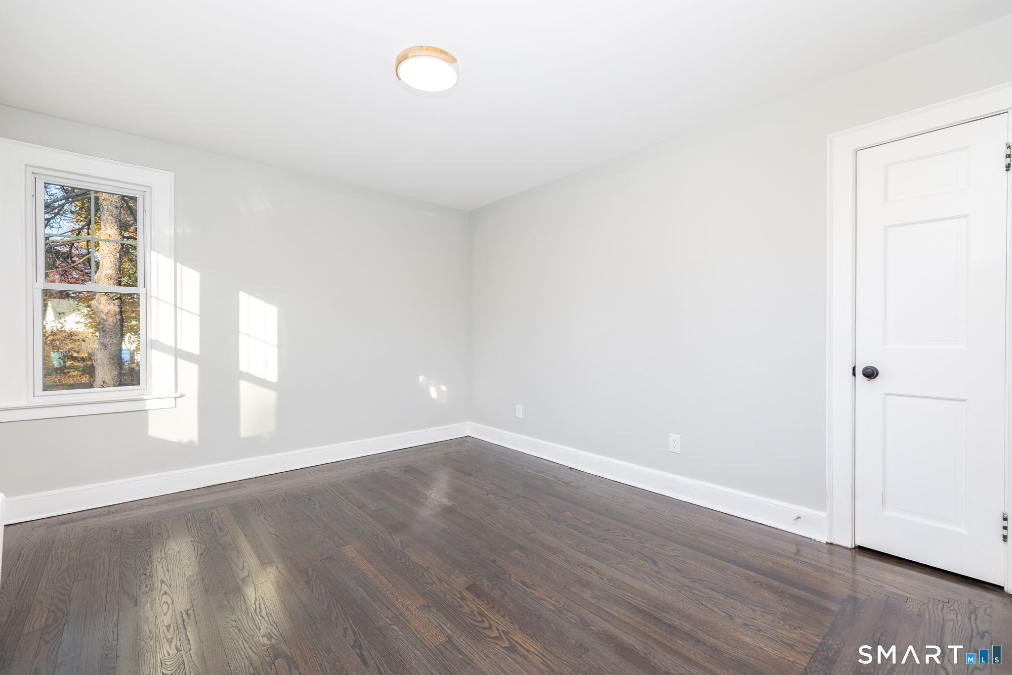 51 Hepburn Road Hamden, CT 06517 - Photo 12 of 40 an empty room with wooden floor and windows