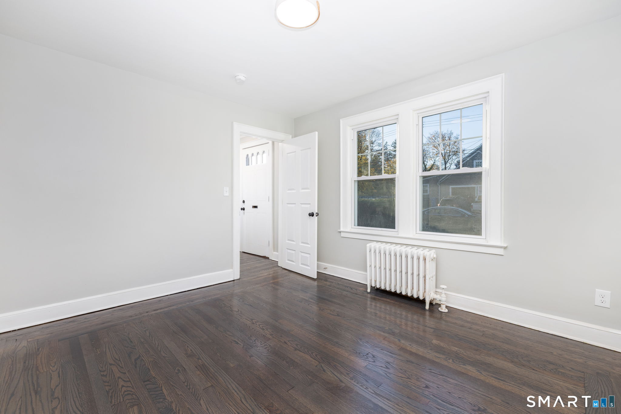 51 Hepburn Road Hamden, CT 06517 - Photo 14 of 40 an empty room with wooden floor and windows