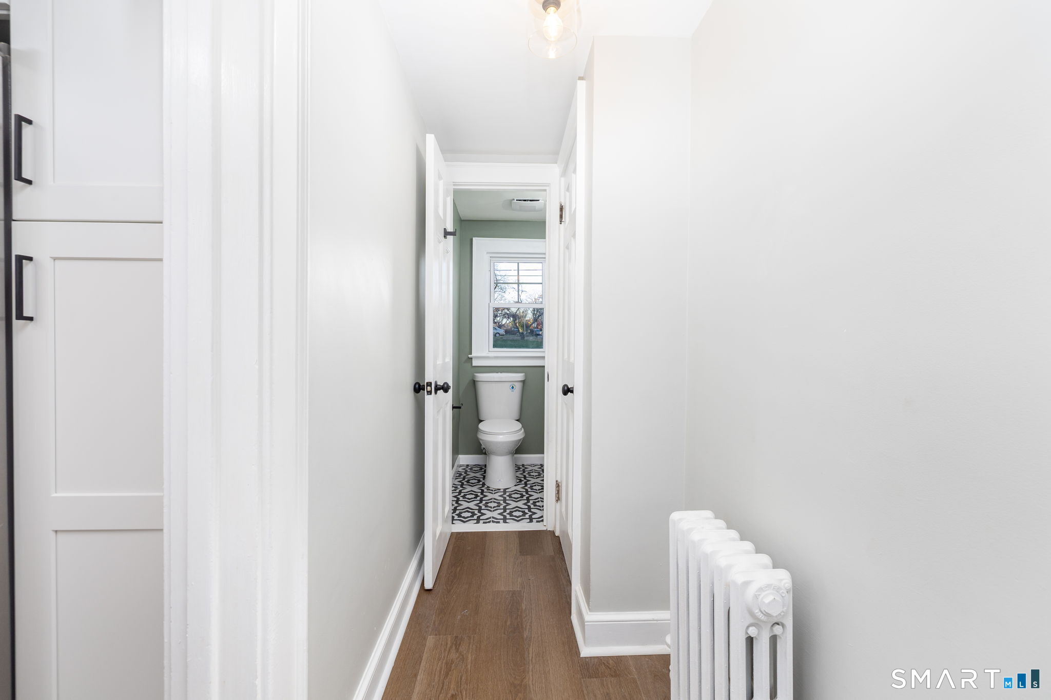 51 Hepburn Road Hamden, CT 06517 - Photo 16 of 40 a view of a hallway with wooden floor and a bathroom