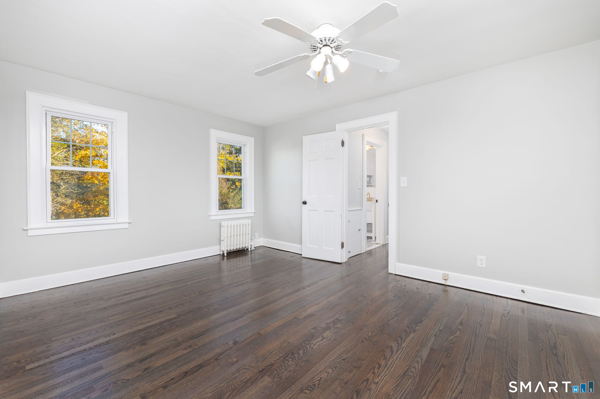51 Hepburn Road Hamden, CT 06517 - Photo 20 of 40 an empty room with wooden floor window and ceiling fan