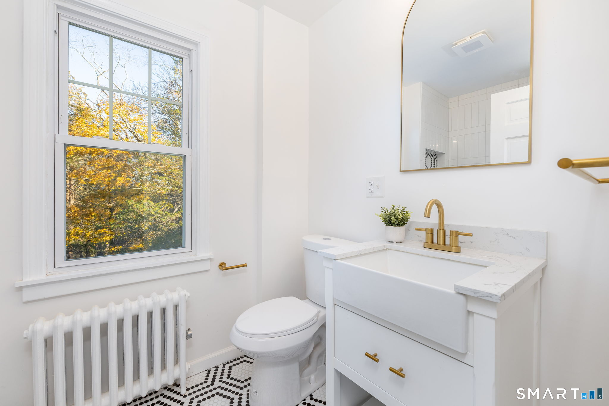 51 Hepburn Road Hamden, CT 06517 - Photo 21 of 40 a bathroom with a sink a toilet and a window