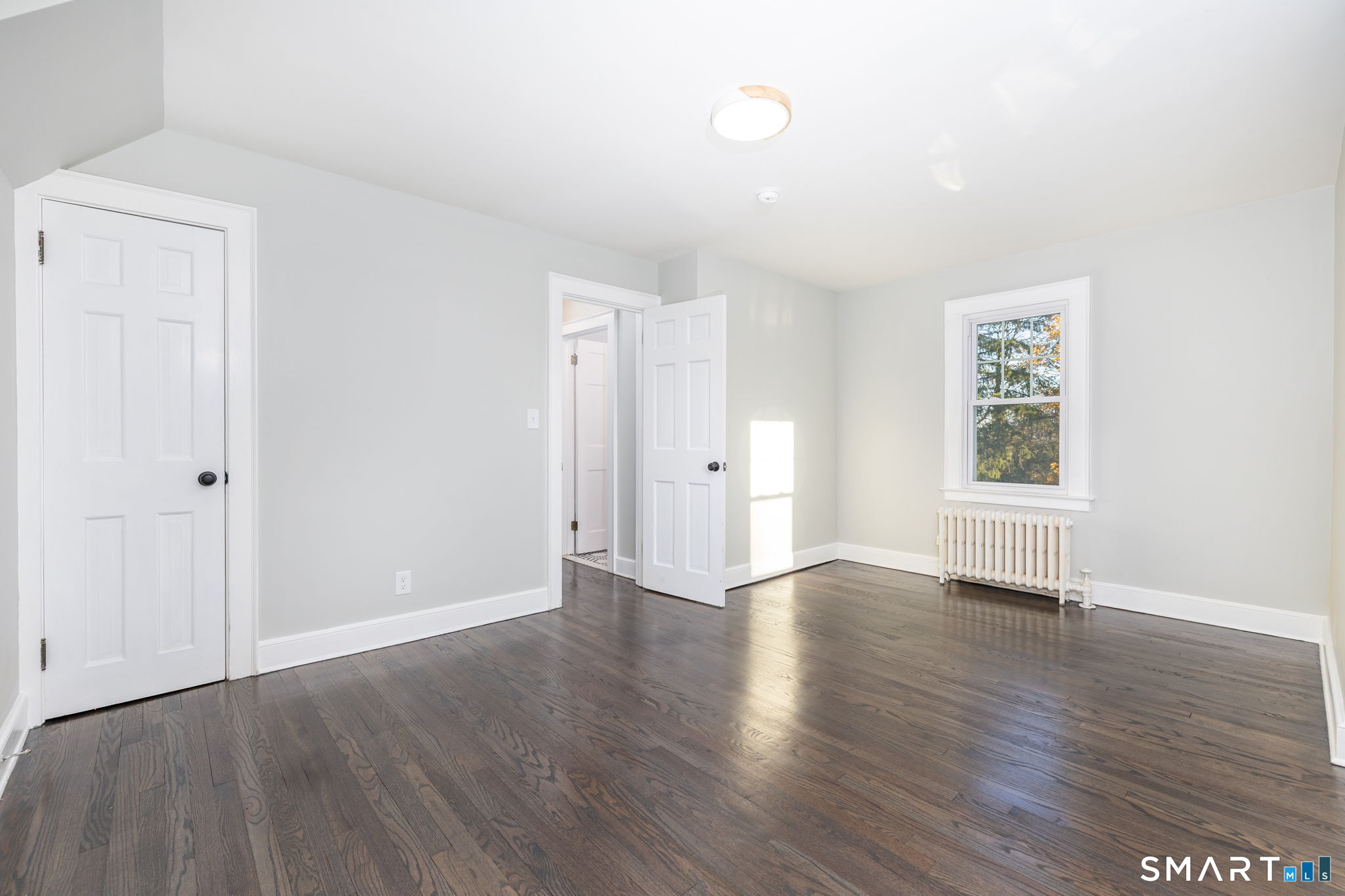51 Hepburn Road Hamden, CT 06517 - Photo 25 of 40 an empty room with wooden floor and windows