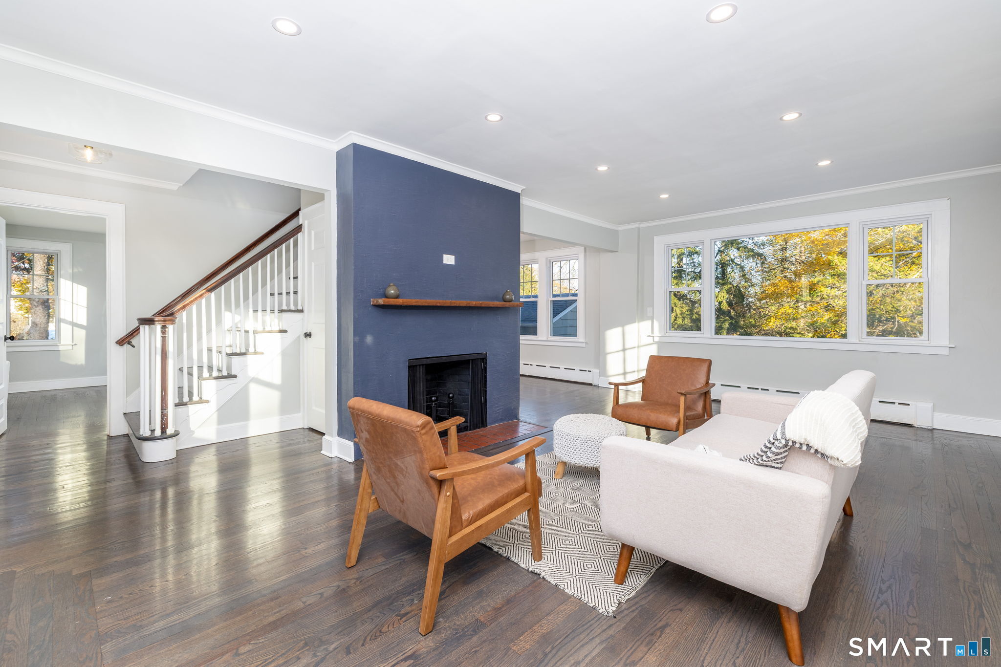51 Hepburn Road Hamden, CT 06517 - Photo 8 of 40 a living room with fireplace furniture and a wooden floor