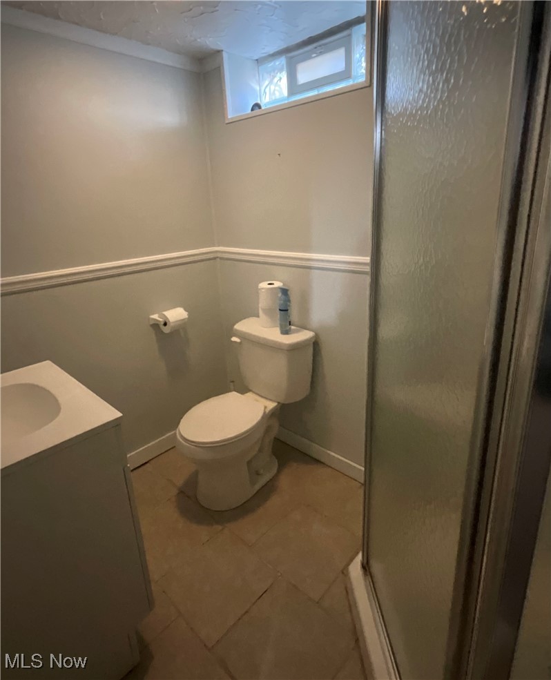 30401 Clarmont Road Willowick, OH 44095 - Photo 17 of 24 Full bath with a stall shower, vanity, and light tile patterned floors