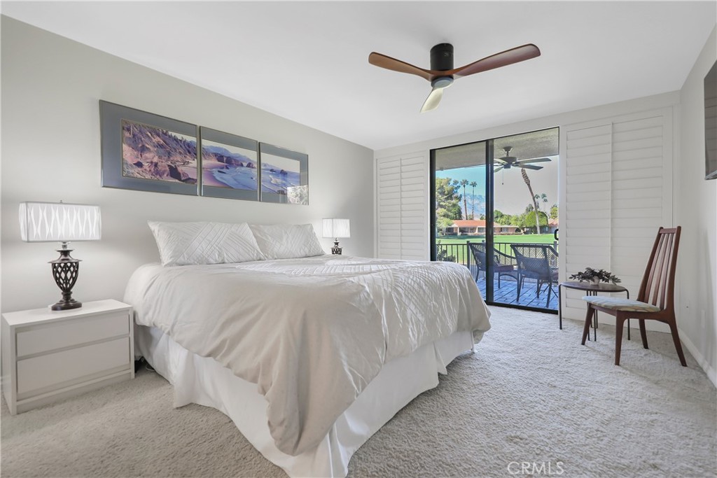 48 Palma Drive Rancho Mirage, CA 92270 - Photo 12 of 32 a bedroom with a bed a desk and chair with a large mirror