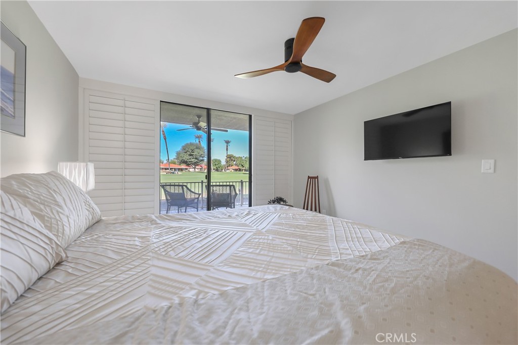 48 Palma Drive Rancho Mirage, CA 92270 - Photo 13 of 32 a bedroom with a large bed and a flat screen tv