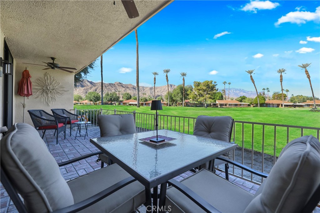48 Palma Drive Rancho Mirage, CA 92270 - Photo 20 of 32 a view of a patio with a table chairs and a yard