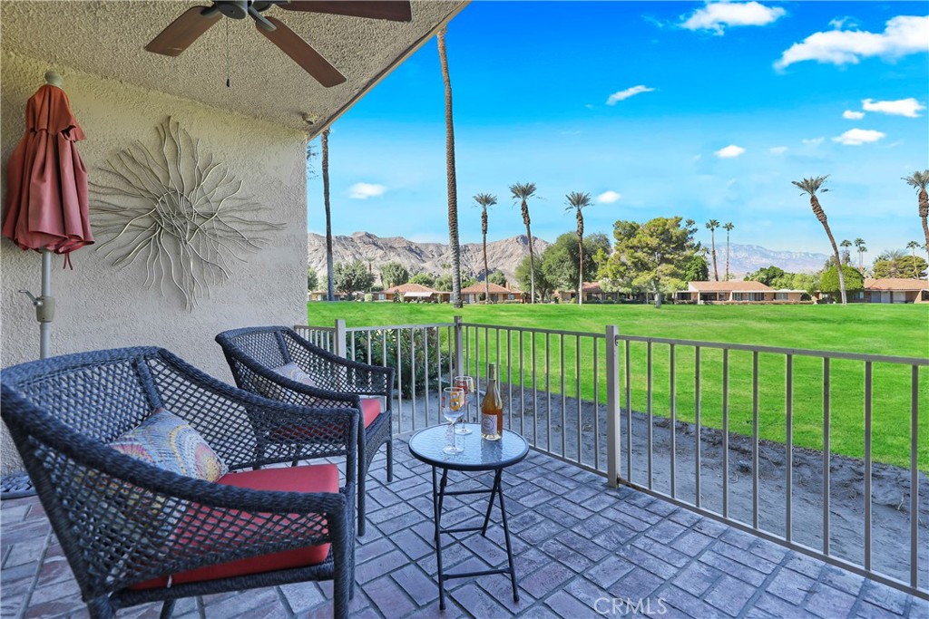 48 Palma Drive Rancho Mirage, CA 92270 - Photo 22 of 32 a view of a chairs and table in patio with a garden