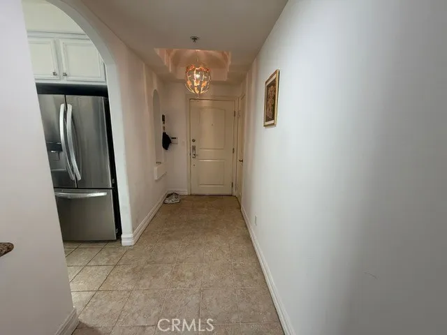 a view of a hallway with a refrigerator