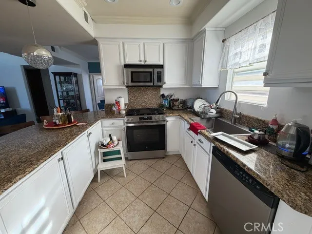 a kitchen with a sink stove top oven and microwave