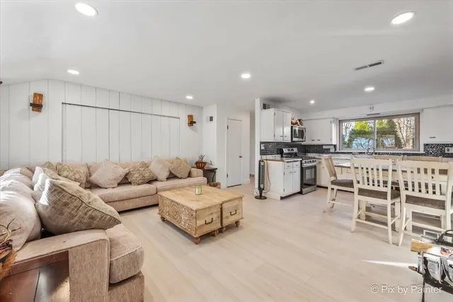 a living room with furniture and kitchen view
