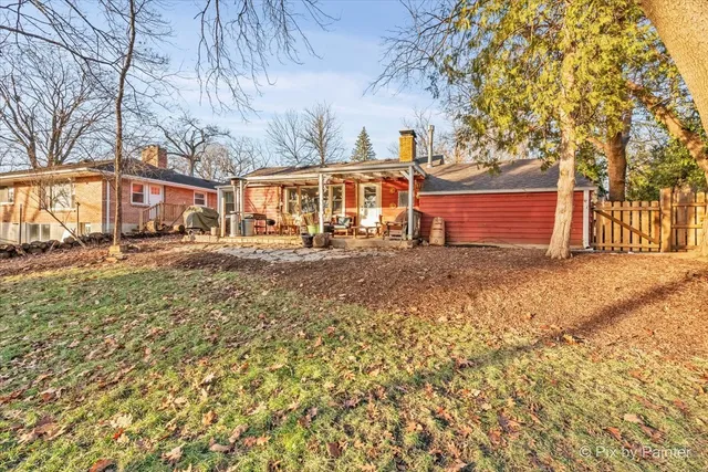 a front view of a house with a yard and trees