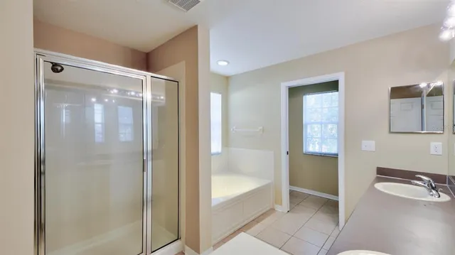 a bathroom with a tub and shower