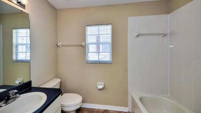 a bathroom with a toilet a sink and bathtub