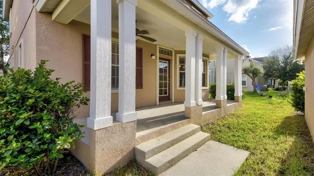 a view of a house with backyard and porch