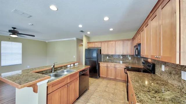 a kitchen with a sink stove and cabinets