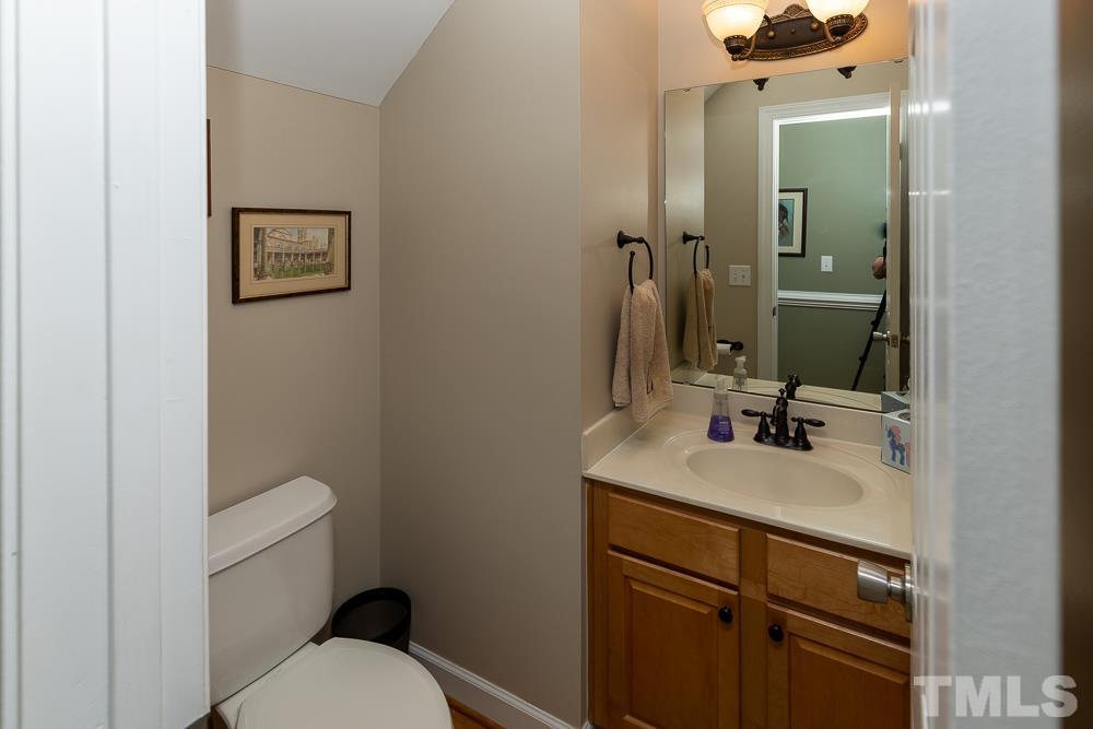 12625 Amoretto Way Raleigh, NC 27613 - Photo 15 of 42 a bathroom with a sink vanity mirror and toilet