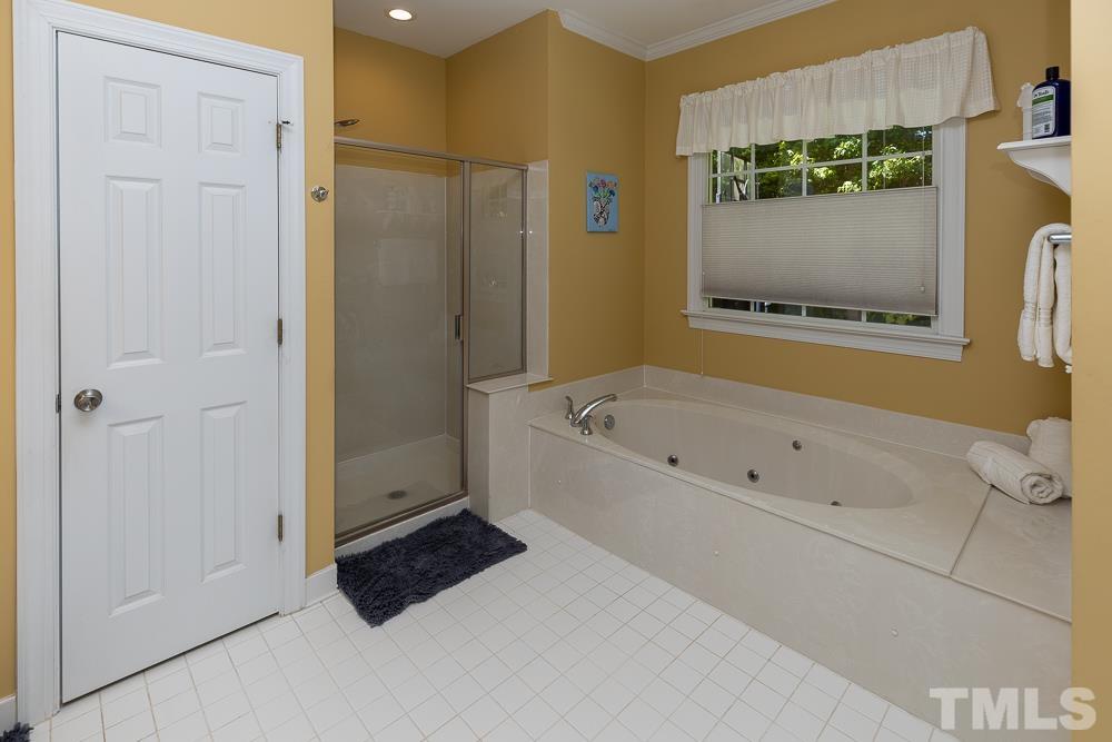12625 Amoretto Way Raleigh, NC 27613 - Photo 19 of 42 a bathroom with a bathtub and a shower