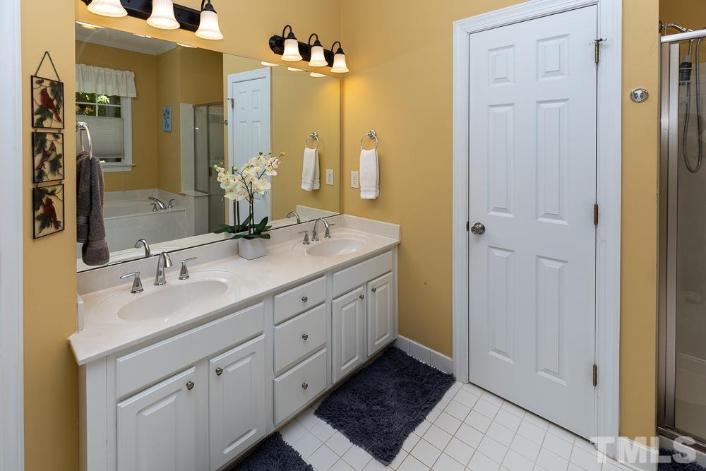 12625 Amoretto Way Raleigh, NC 27613 - Photo 20 of 42 a bathroom with a double vanity sink and a mirror