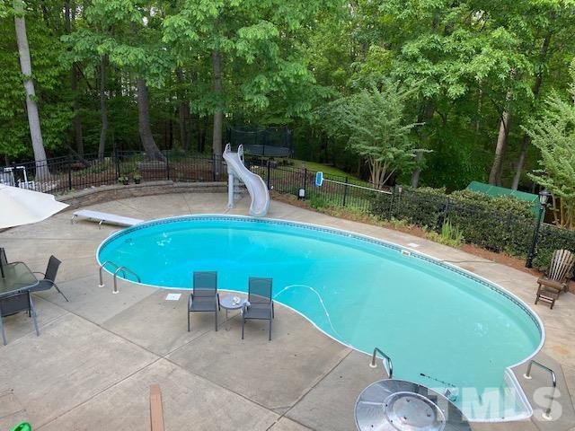 12625 Amoretto Way Raleigh, NC 27613 - Photo 2 of 42 a view of a swimming pool with a patio