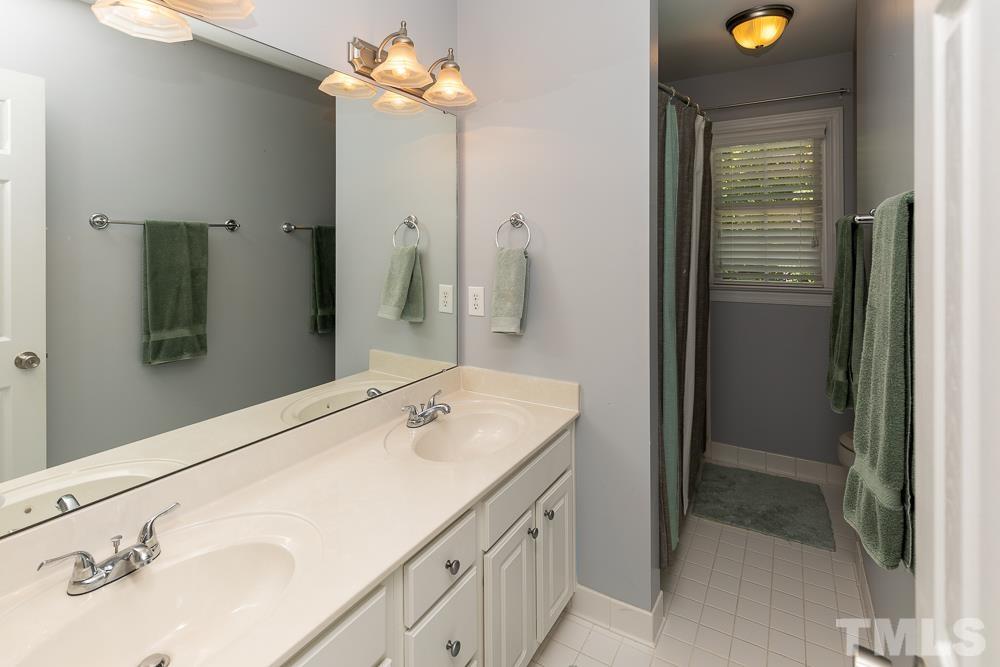 12625 Amoretto Way Raleigh, NC 27613 - Photo 25 of 42 a bathroom with a sink and a mirror