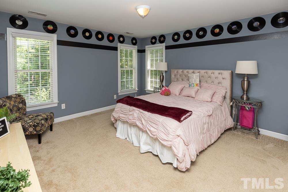 12625 Amoretto Way Raleigh, NC 27613 - Photo 26 of 42 a bedroom with a bed and a window