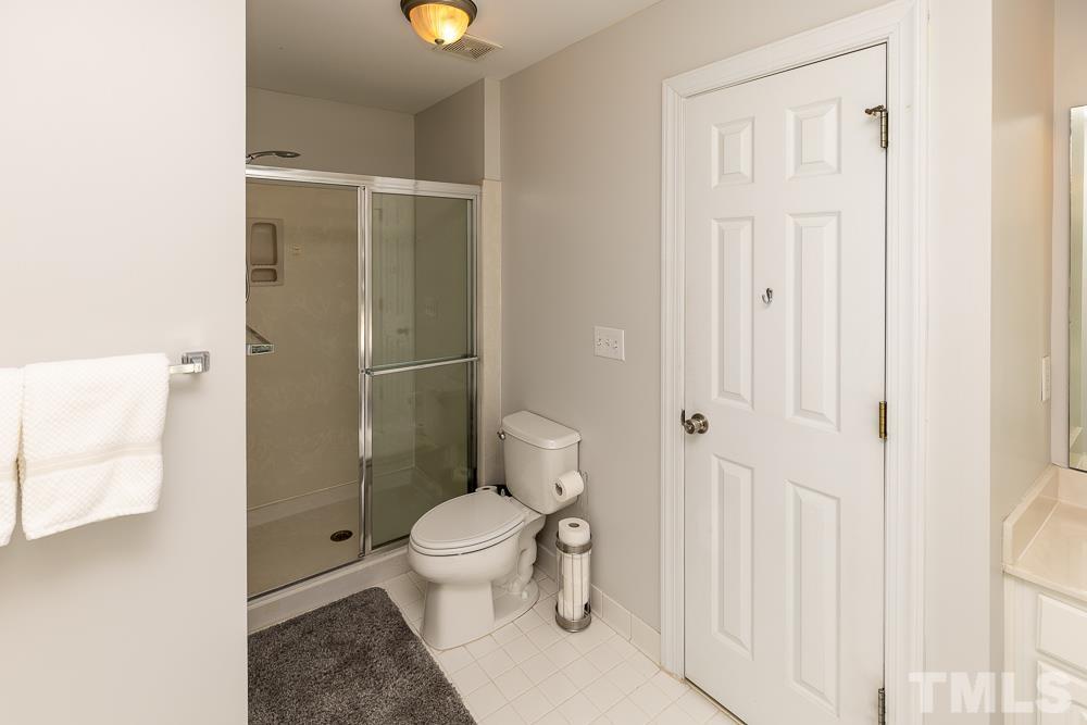 12625 Amoretto Way Raleigh, NC 27613 - Photo 30 of 42 a bathroom with a toilet and a shower