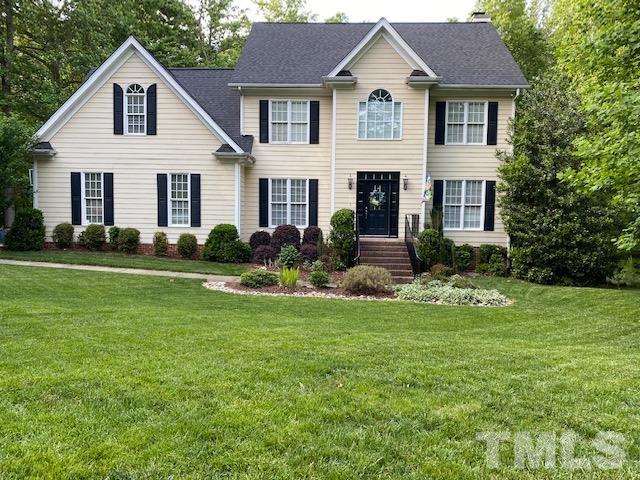 12625 Amoretto Way Raleigh, NC 27613 - Photo 3 of 42 a view of a yard in front of a house with plants and large trees