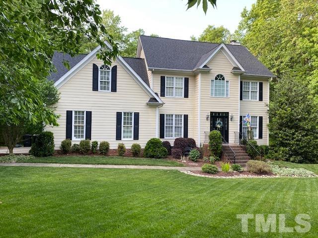 12625 Amoretto Way Raleigh, NC 27613 - Photo 4 of 42 a front view of a house with a yard and garage