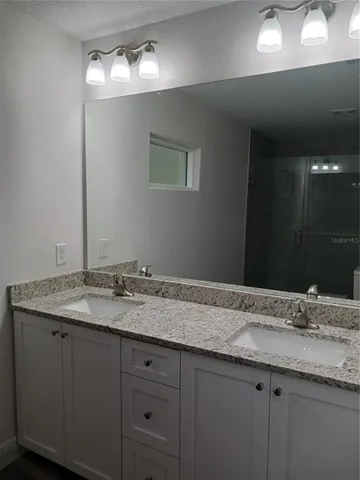 a bathroom with a shower a toilet and sink