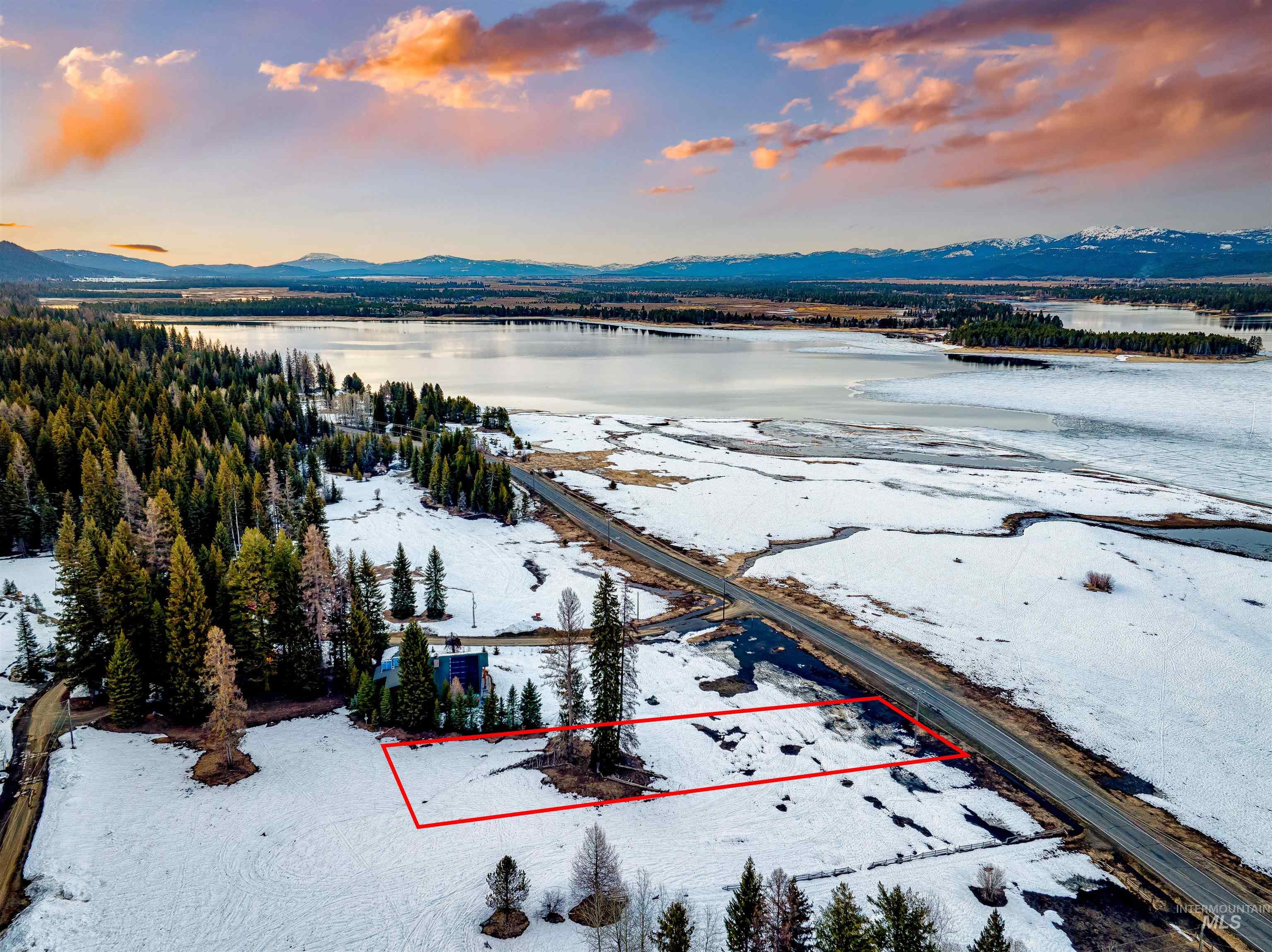 2273 West Mountain Road Donnelly, ID 83615 - Photo 13 of 19 Aerial view of property and surrounding area with property parcel outlined and a water and mountain view