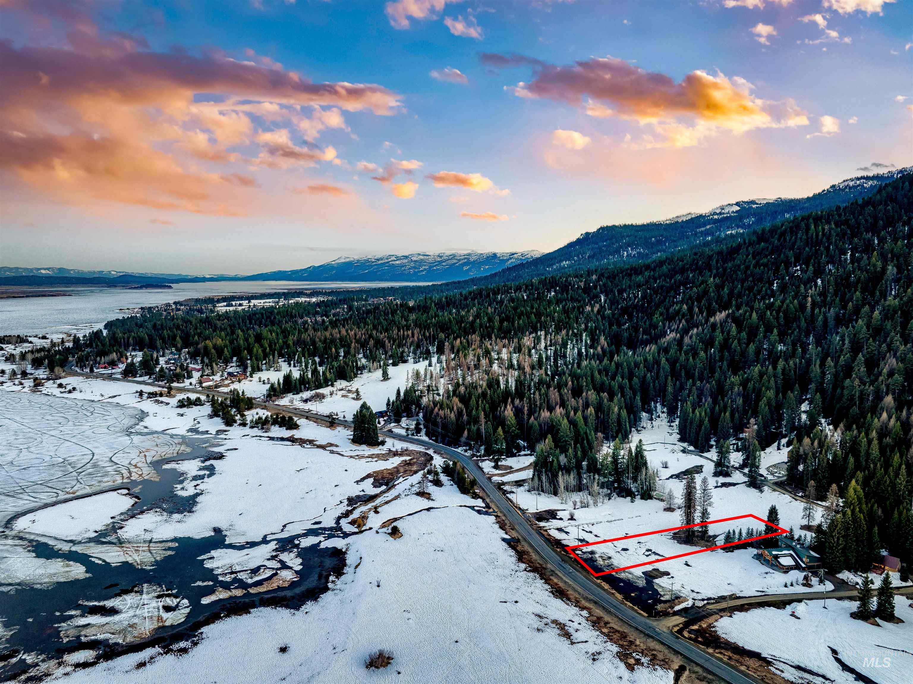 2273 West Mountain Road Donnelly, ID 83615 - Photo 19 of 19 Snowy aerial view with a mountain view and a view of trees