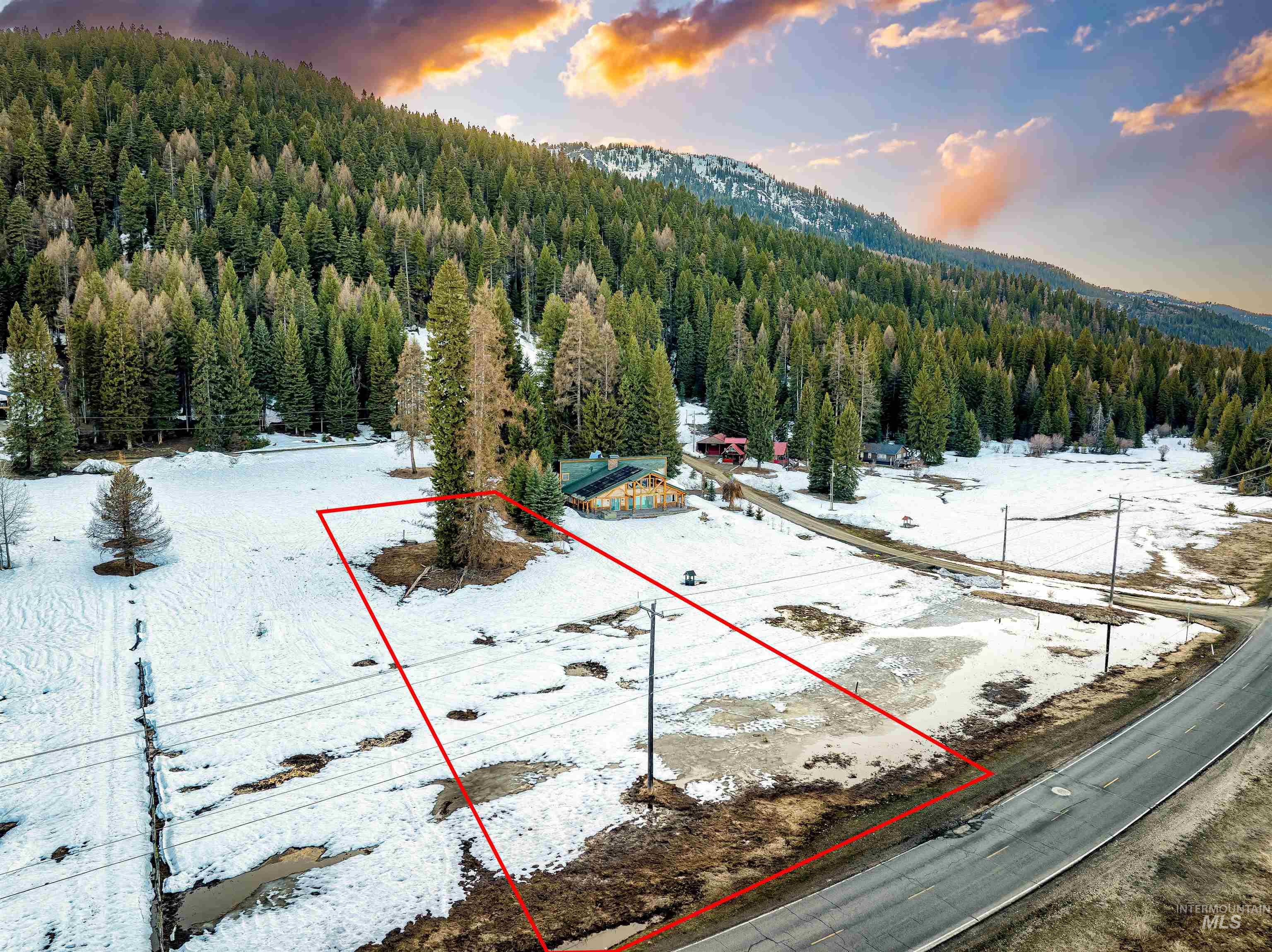 2273 West Mountain Road Donnelly, ID 83615 - Photo 3 of 19 Aerial view at dusk of property boundaries highlighted, a view of trees, and a mountain view