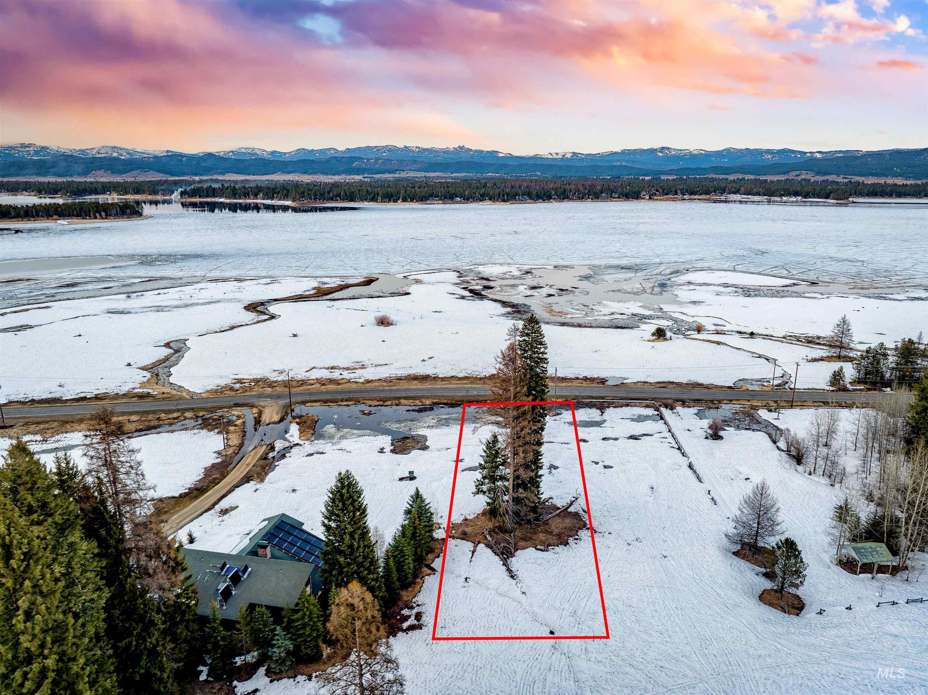 2273 West Mountain Road Donnelly, ID 83615 - Photo 9 of 19 Snowy aerial view featuring property boundaries highlighted and a mountain view