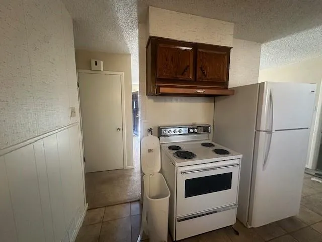 a kitchen with a stove microwave and refrigerator